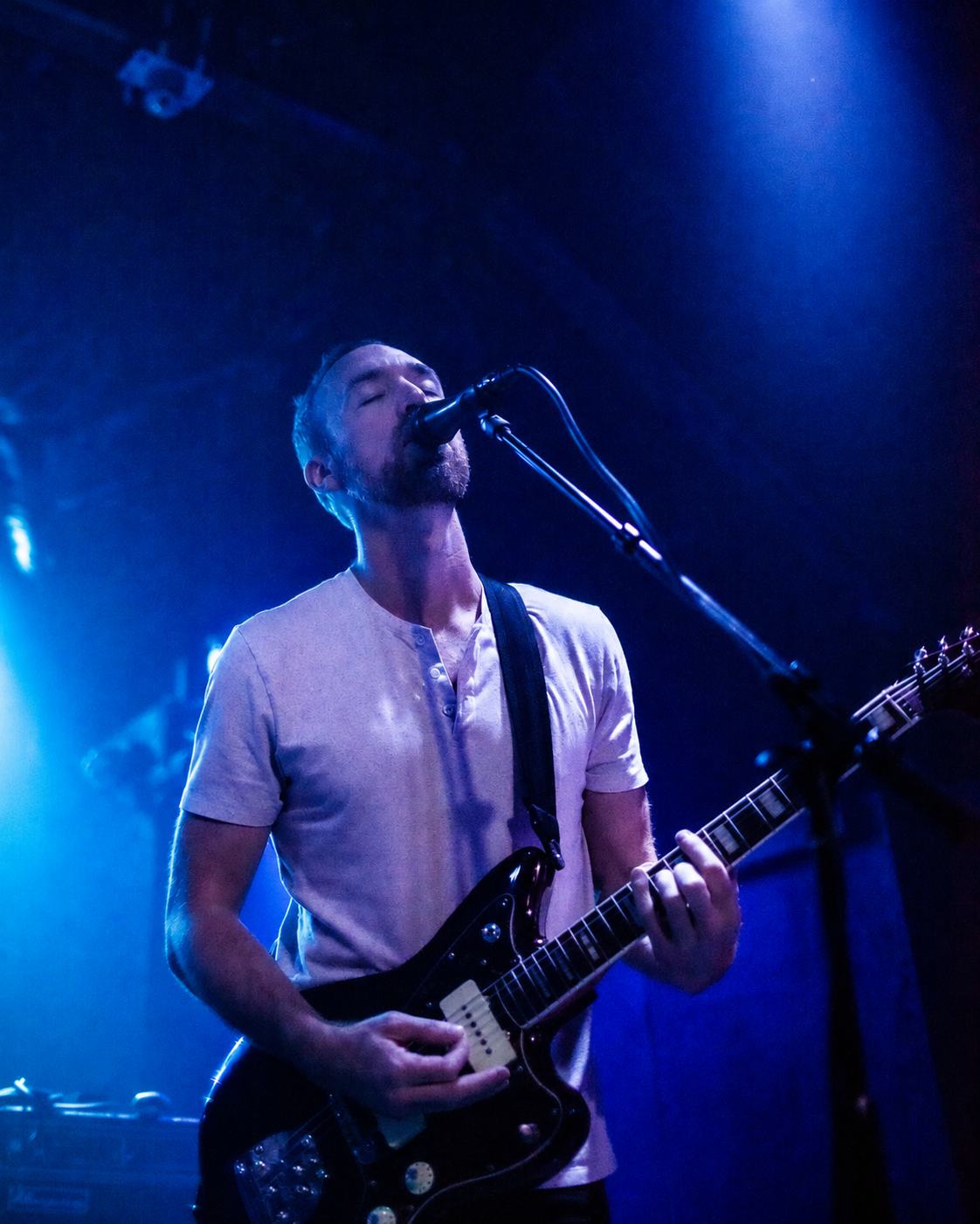 Nervous Bride performing live under blue stage lights